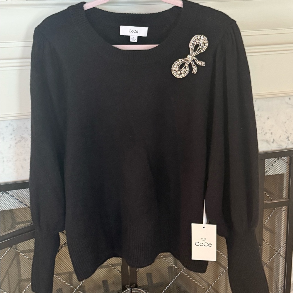 CeCe Black Sweater beaded with a silver bow size L.  BNWT from Macy’s